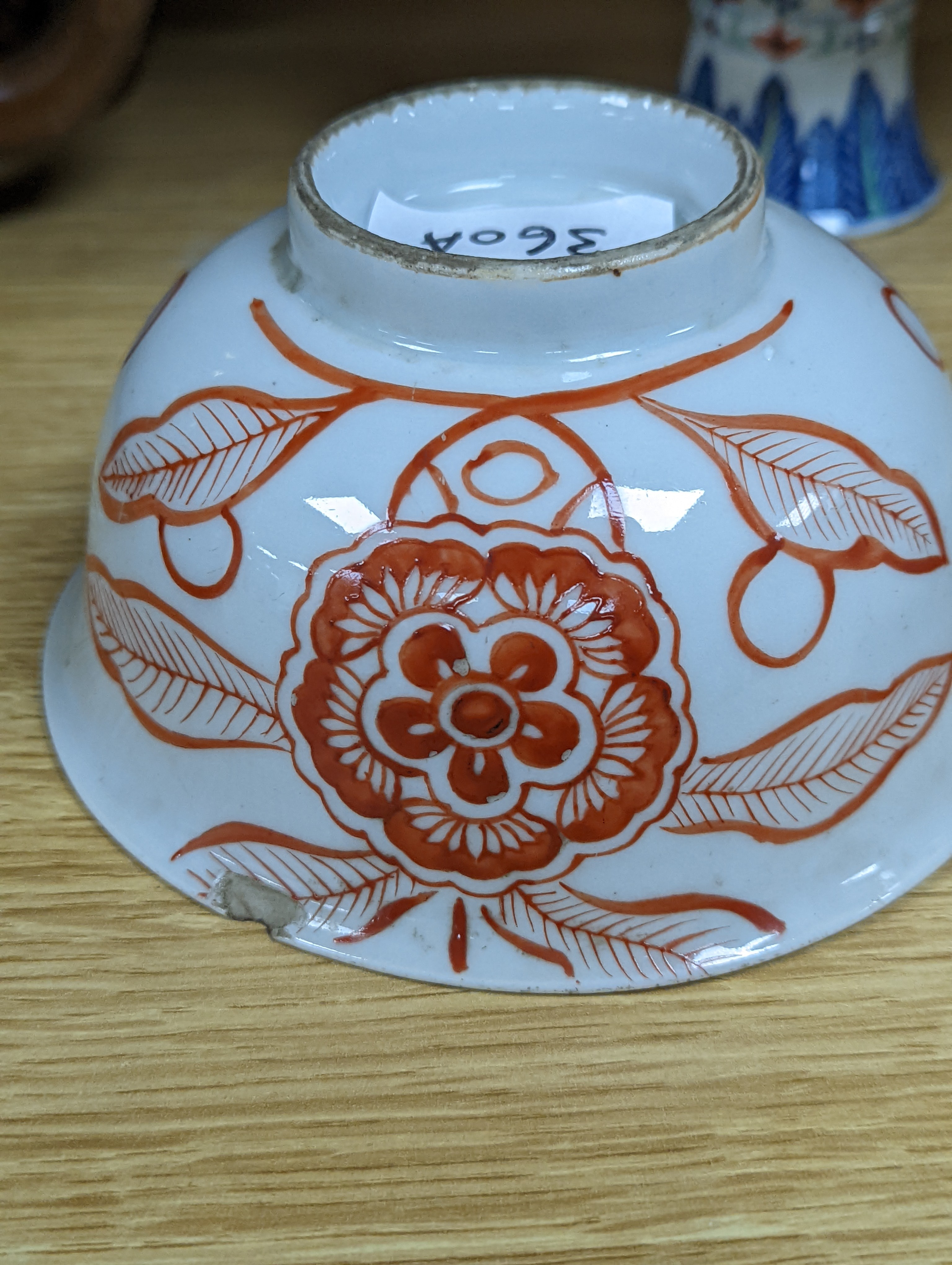 A Chinese blue and white water pipe vessel, a doucai stem dish and a Japanese Imari bowl, 19th century, (3)